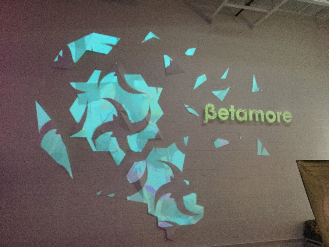 Betamore wall installation with cyan projections on 3D relief